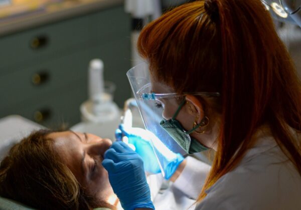 Dentist performing dental procedure on patient in clinic