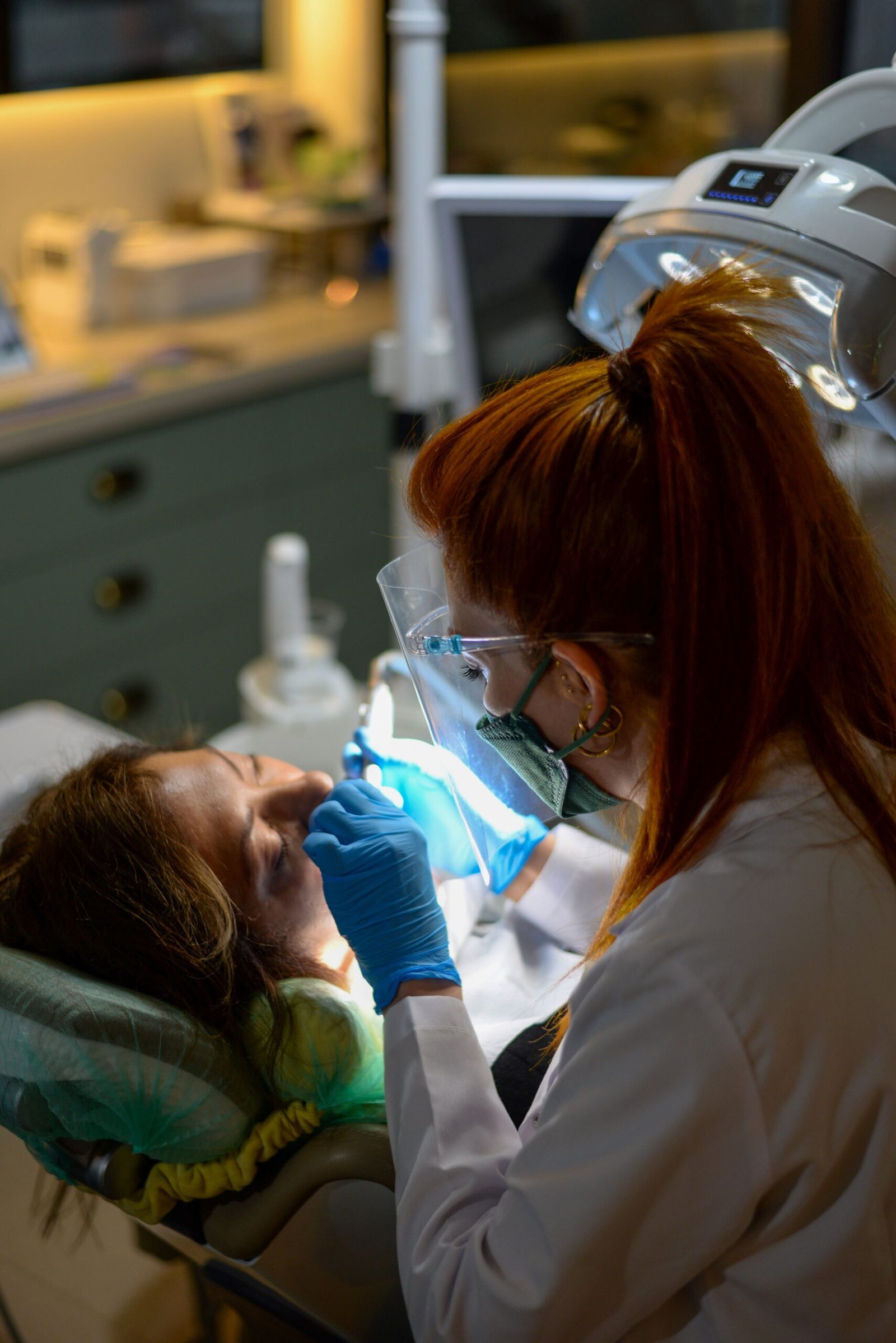 Dentist performing dental procedure on patient in clinic