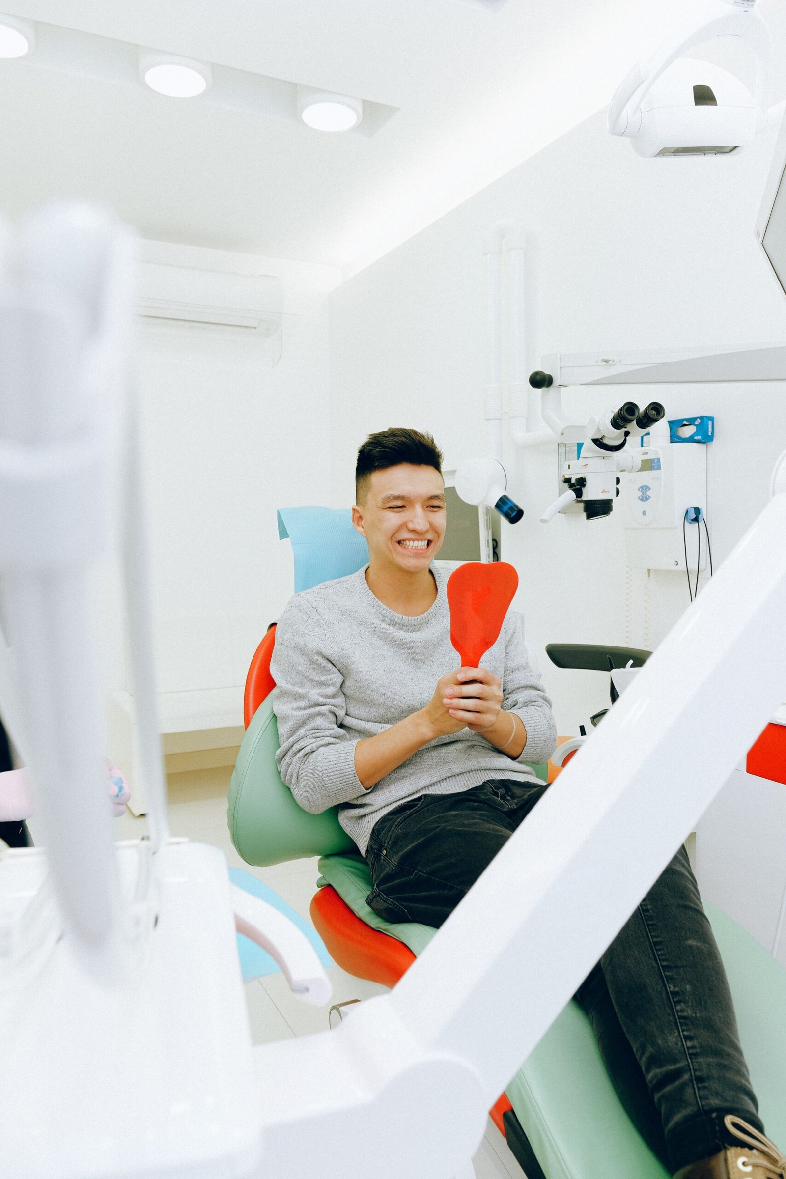 Happy young patient in dental clinic awaiting treatment