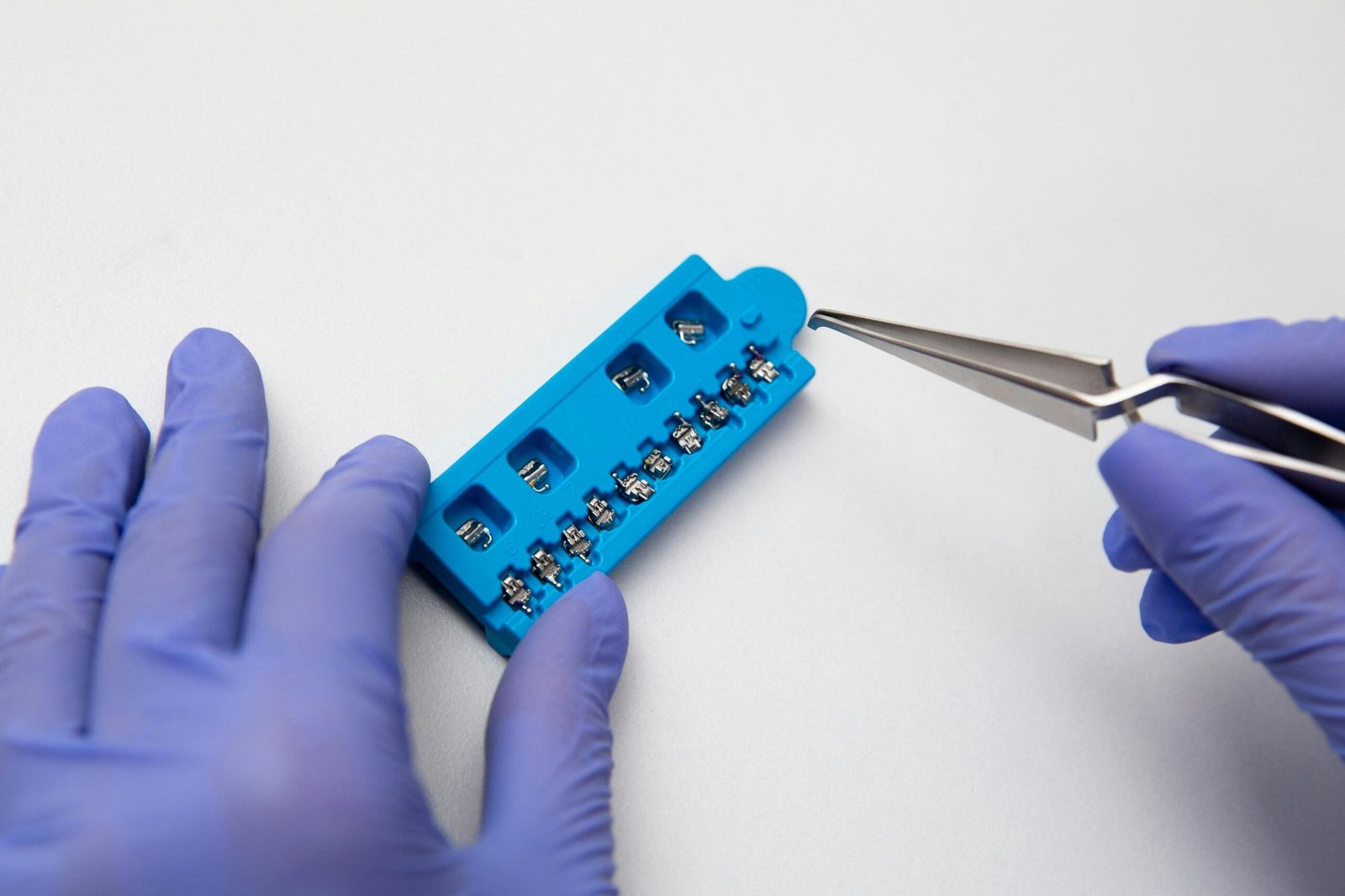 Hands of dentist with dental braces system close-up